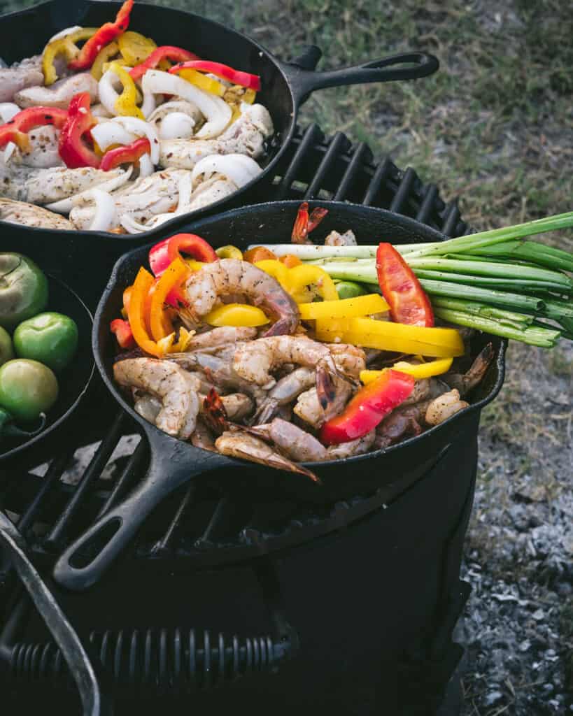 pan of shrimp fajitas and bell peppers on grill