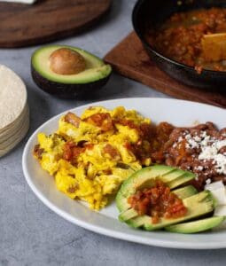 plate of eggs, beans, avocado cheese