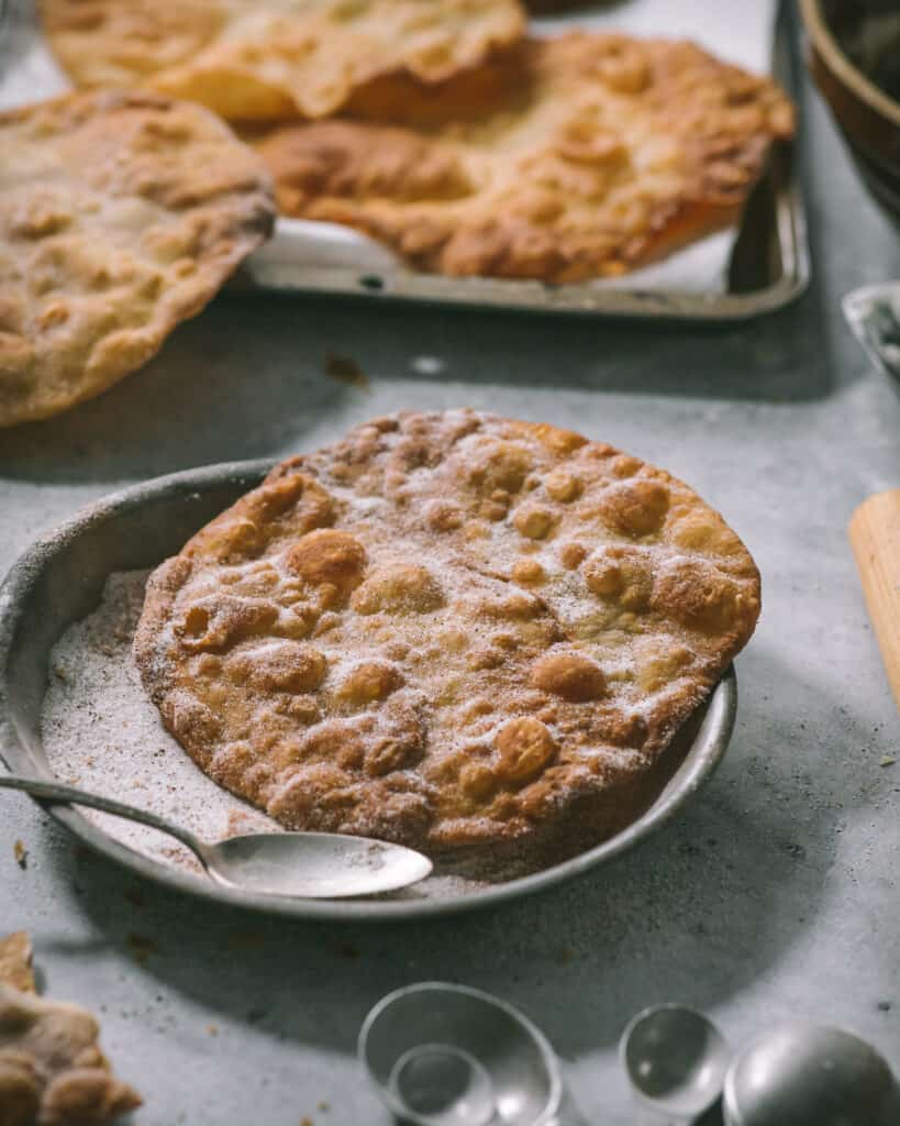 buñuelo on a plate of sugar