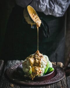 Instant Pot Queso Dip with Chorizo pouring over cauliflower