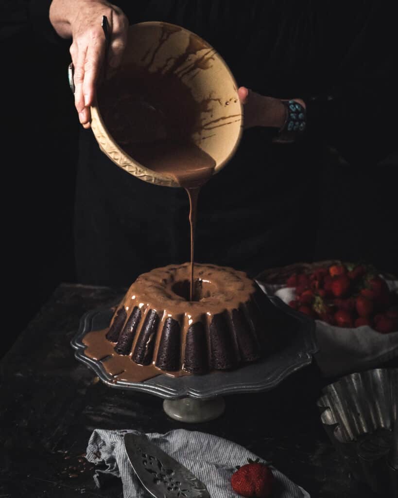 chocolate pouring over cake