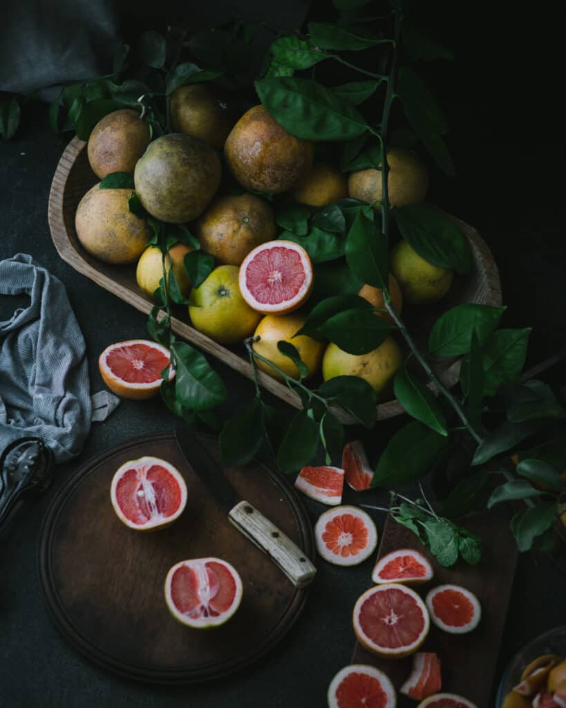 moody still life of fruit in wooden tray