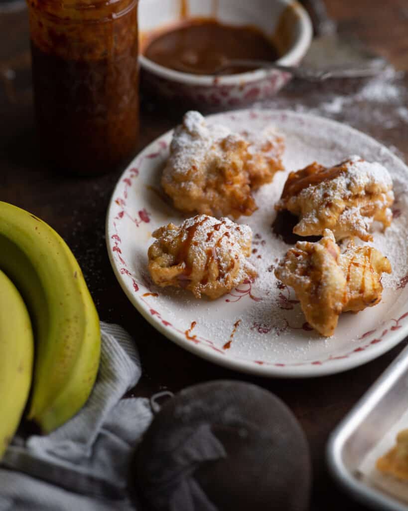 Platter of banana fritters with dulce de leche glaze