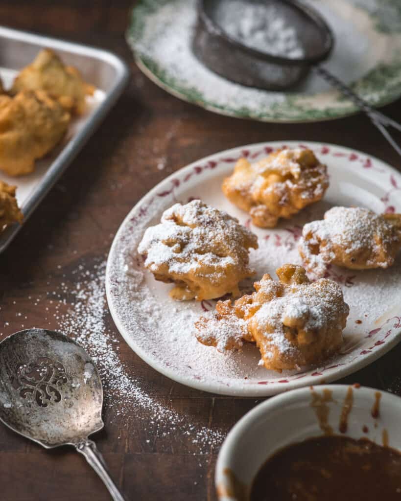 platter of fritters dusted with powdered sugar
