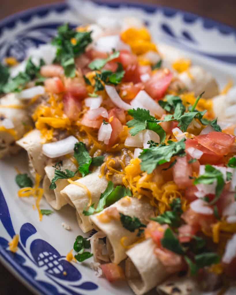 close up of tacos smothered in bean sauce