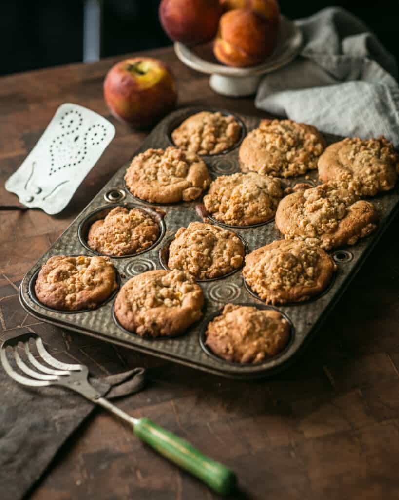 baking tray of freshly baked peach muffins