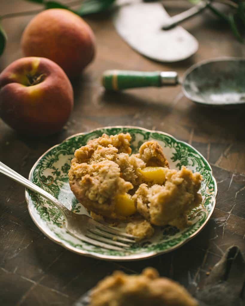 peach muffin on a plate showing peach chunks