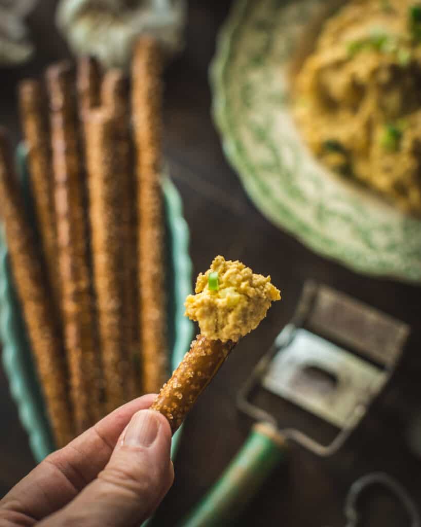 close up of cheese spread on pretzel stick