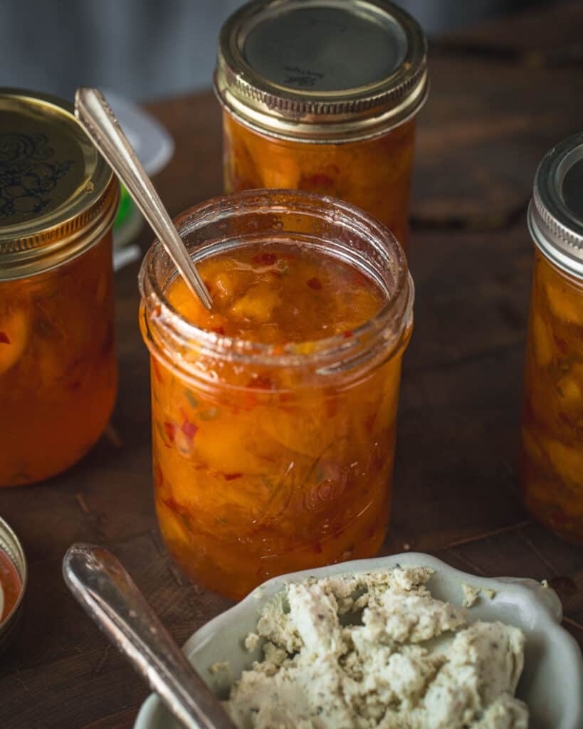 bowl of goat cheese with jar of jam