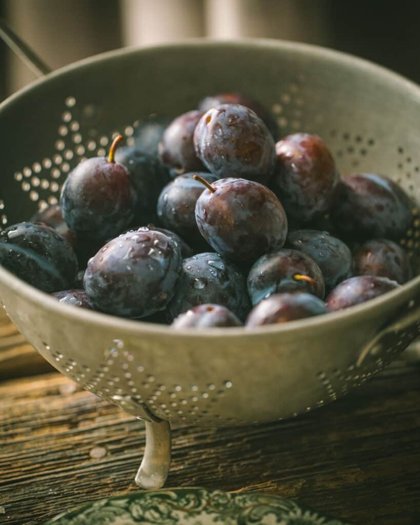 close up of colander of plums