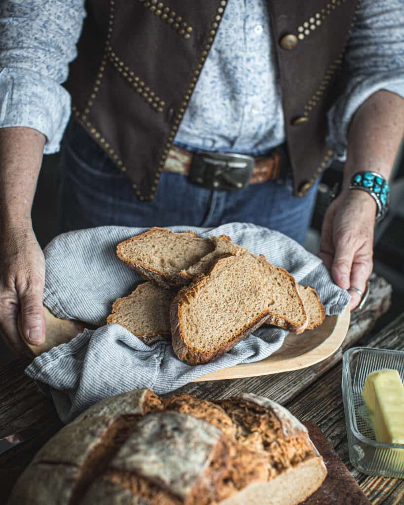 woman holding Country Style Sourdough Bread in tray