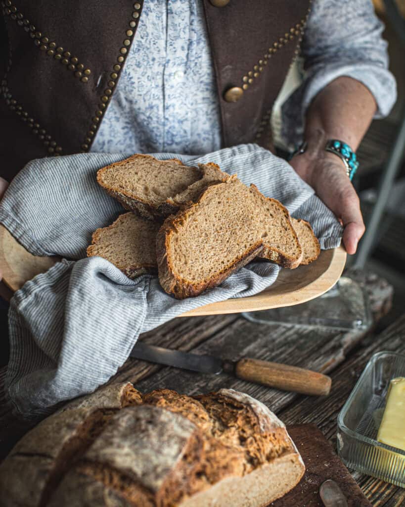 woman holding Country Style Sourdough Bread in tray
