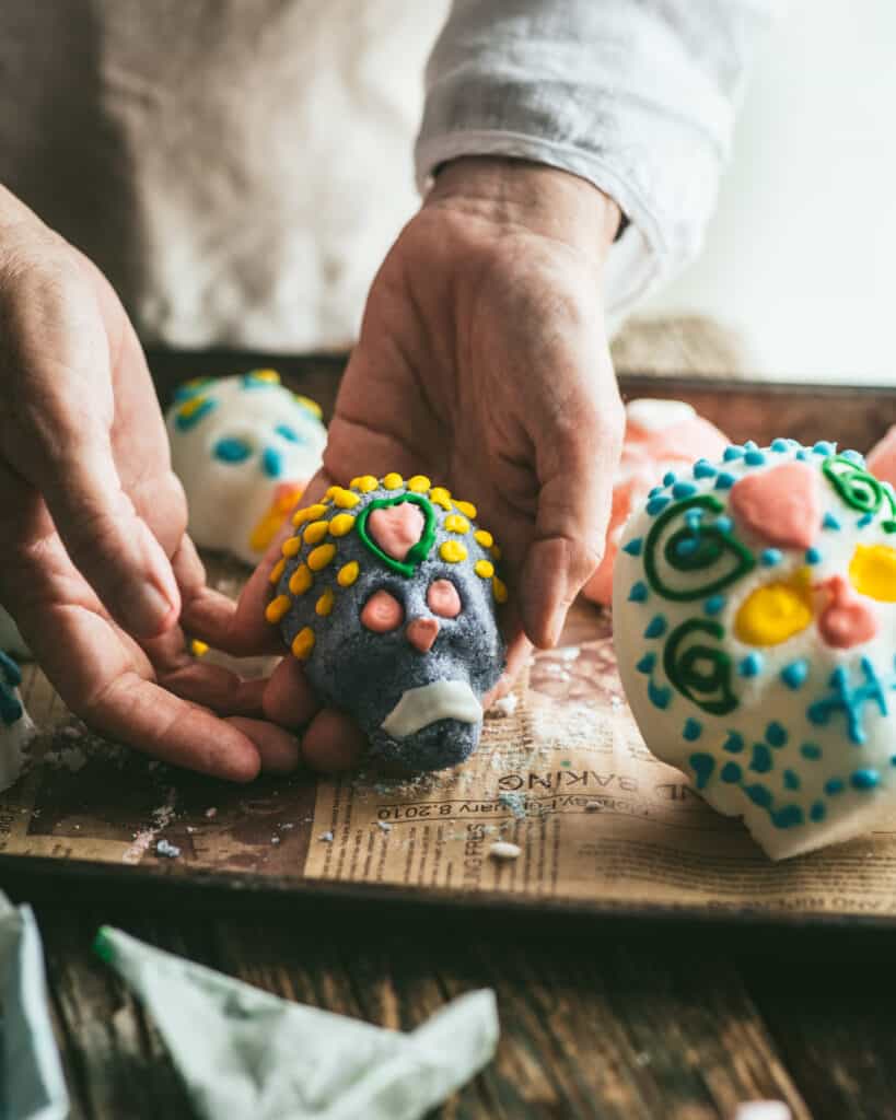 Woman holding sugar skull with hands