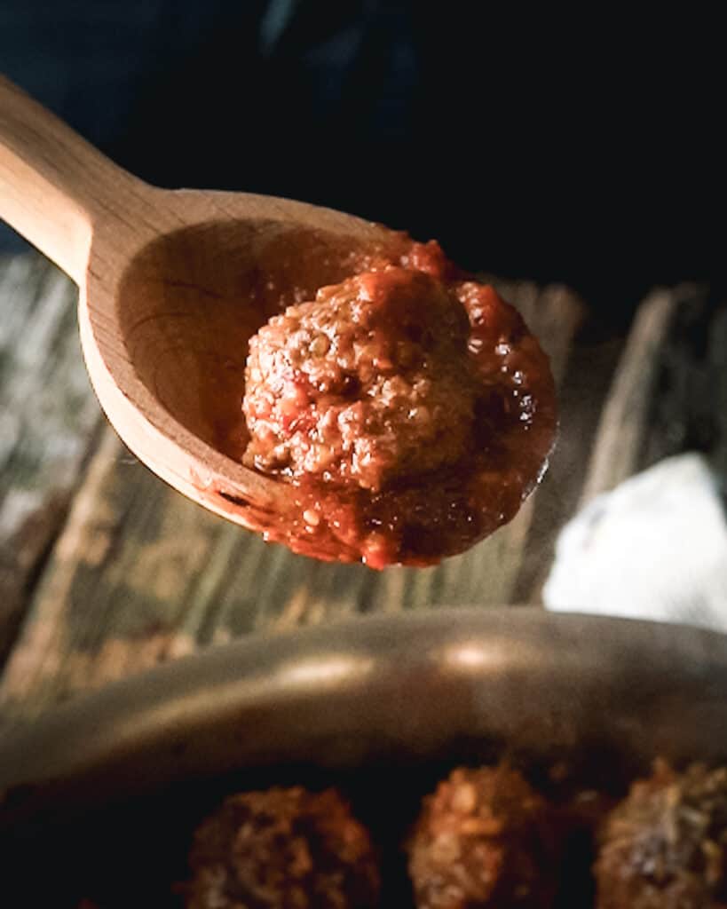 Albondigas de chipotle on a spoon