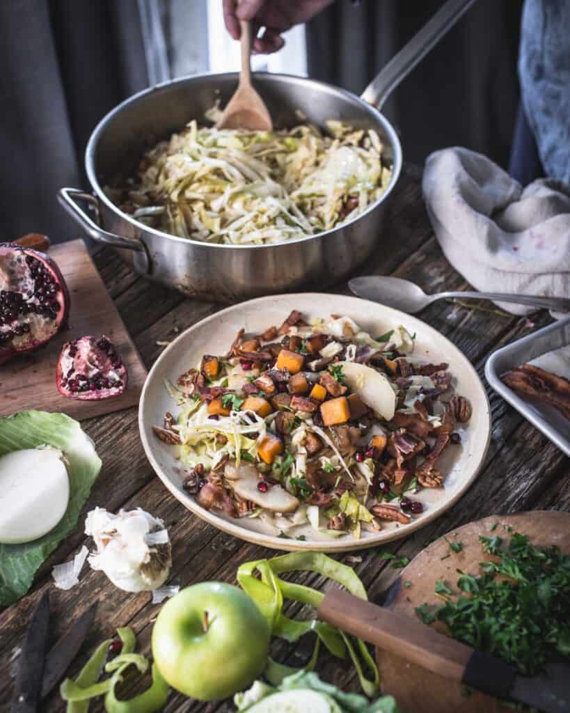 woman serving fried cabbage winter salad