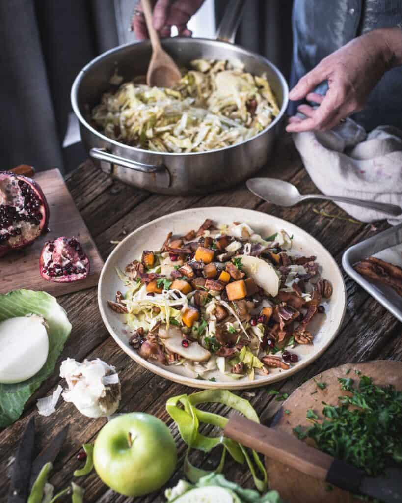 woman serving fried cabbage winter salad