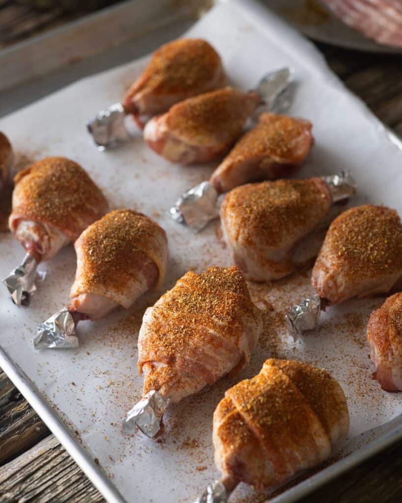 Uncooked Spicy Chicken Lollipop on a tray