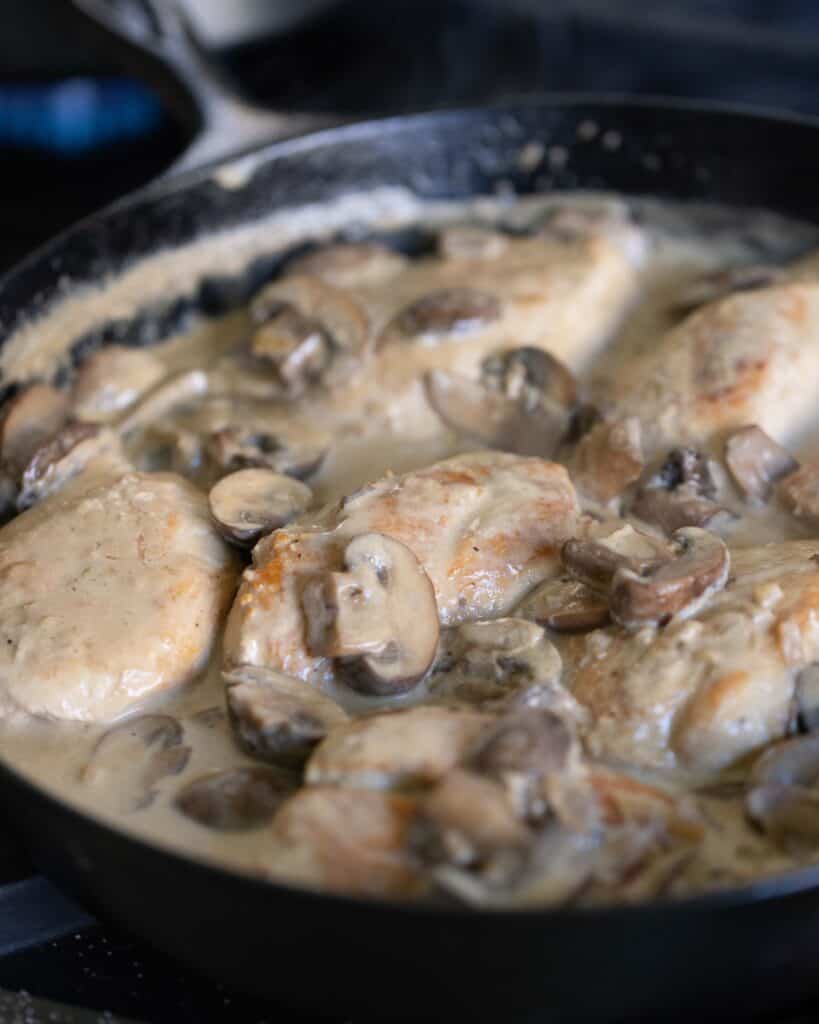 Cast iron pan of Whiskey Chicken with mushrooms