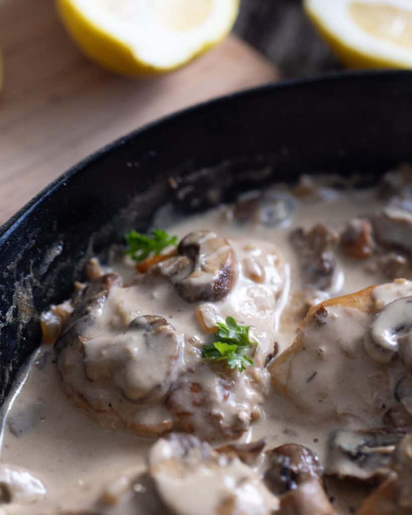 pan of chicken breasts with mushrooms