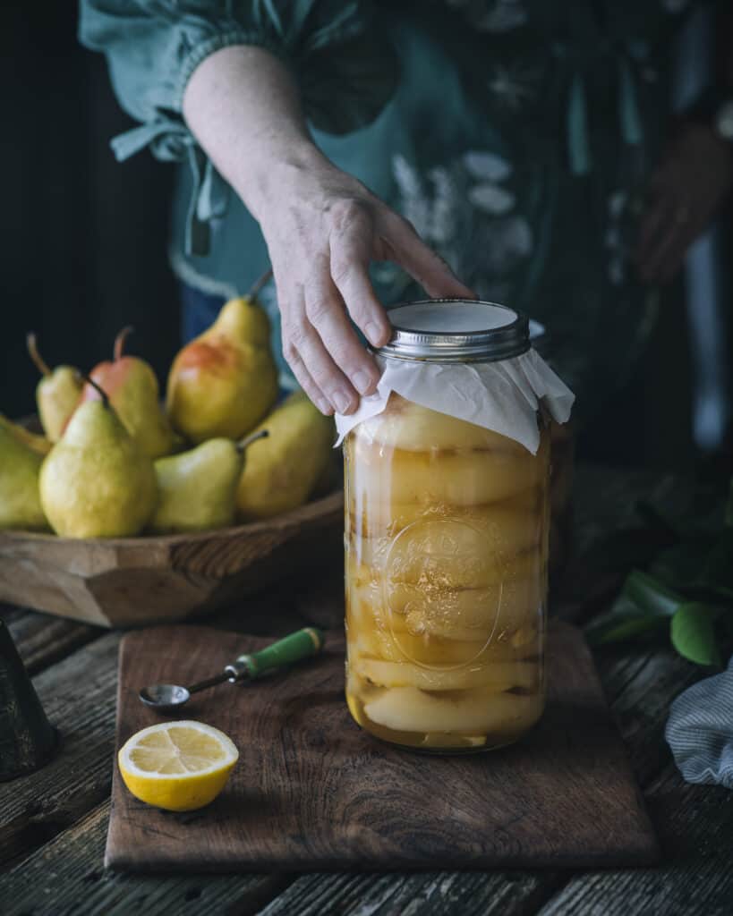 woman holding jar of honey ginger pears