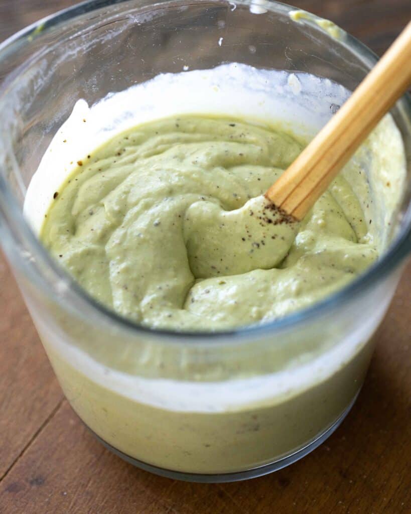 overhead pic of avocado ranch dressing in measuring cup