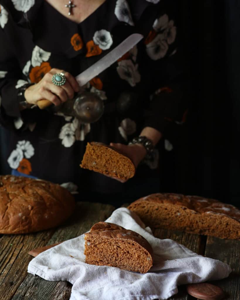 woman cutting bread with a knife