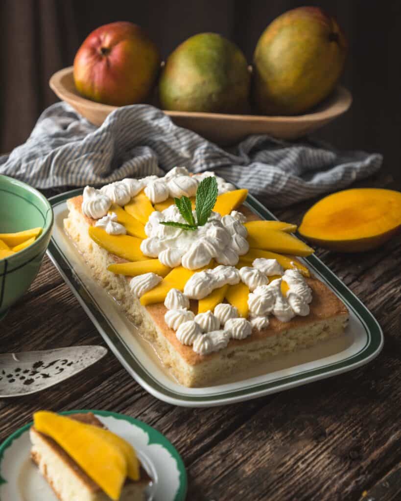 platter of cake with arrangement of mangoes in a tray