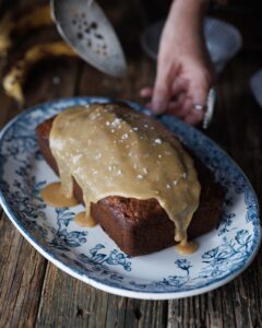 woman holding platter of banana bread